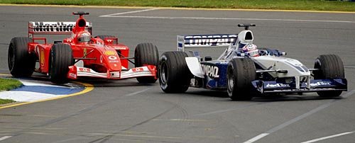 Montoya holds M. Schumacher at bay.