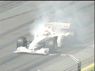 Herbert's car goes up in smoke on the starting grid