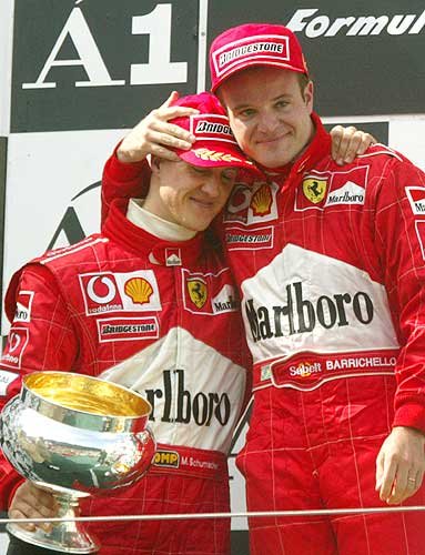 M. Schumacher puts Barrichello on the highest step of the podium.