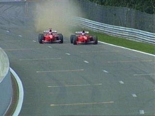 The two Ferrari almost collide when Irvine comes out of the pits