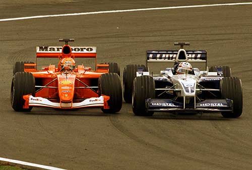 Montoya muscles his way past M. Schumacher.