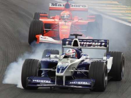 Montoya locks his wheels but M. Schumacher cannot go through.
