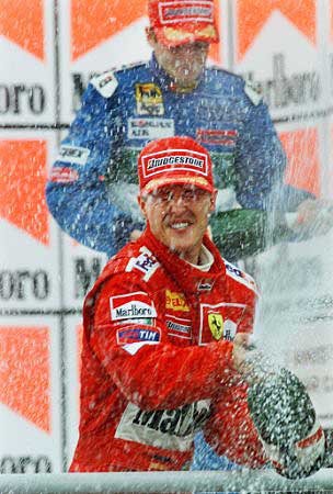 M. Schumacher and Fisichella spray champagne on the public.