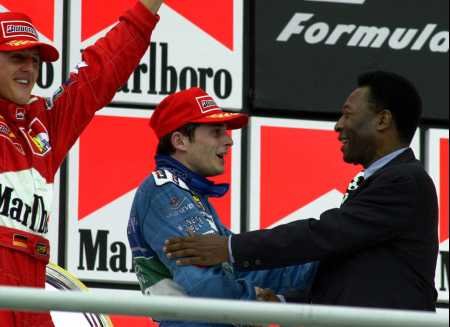 Fisichella, in awe, shakes hands with football legend Pele.