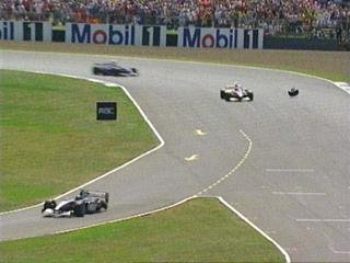 Hakkinen loses a tyre in front of the pit lane