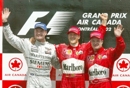 The podium. M. Schumacher, who brought Ferrari their 150th victory, Coulthard and Barrichello.