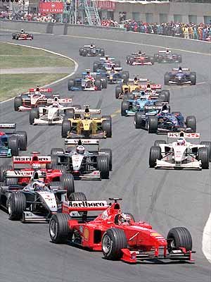 The start. M. Schumacher cuts across the field and prevents Hakkinen from taking the lead