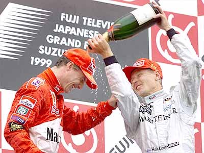No hard feelings ...Hakkinen and Irvine play with Champagne on the podium.
