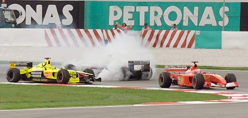 Barrichello goes ahead of R. Schumacher, who spins.