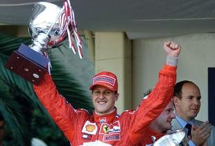M. Schumacher holds the winner's trophy