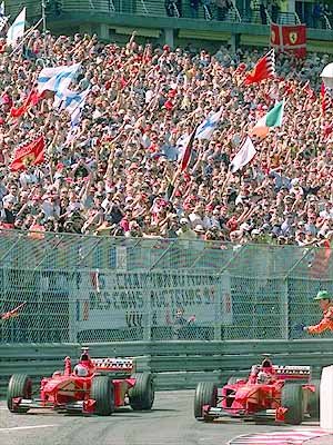 The two Ferrari drivers go for their triumph lap in front of their fans