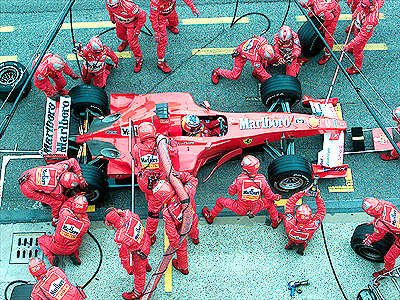 A masterful pit stop strategy puts M. Schumacher in the lead.
