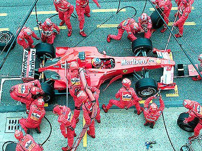 A masterful pit stop strategy puts M. Schumacher in the lead.