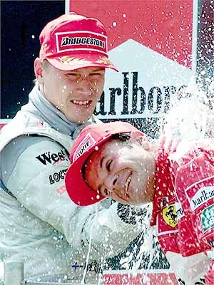 Hakkinen sprays Barrichello with champagne.